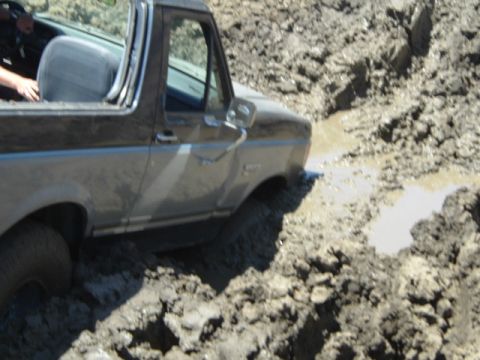 1989 Ford Bronco - This 1989 Ford Bronco is deeply stuck in thick mud, with its front end partially submerged.