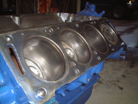 1967 Ford Galaxie - The internal cylinders of a blue engine block are visible, showing wear marks.