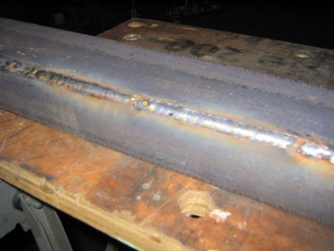 1978 Ford Bronco - A close-up of a welded steel joint, showing a MIG or stick weld bead running along two metal pieces with visible heat discoloration and spa…