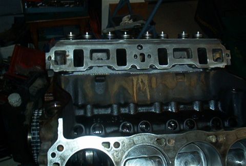 1986 Ford Bronco - Close-up view of an engine block and cylinder head assembly, showing internal components.