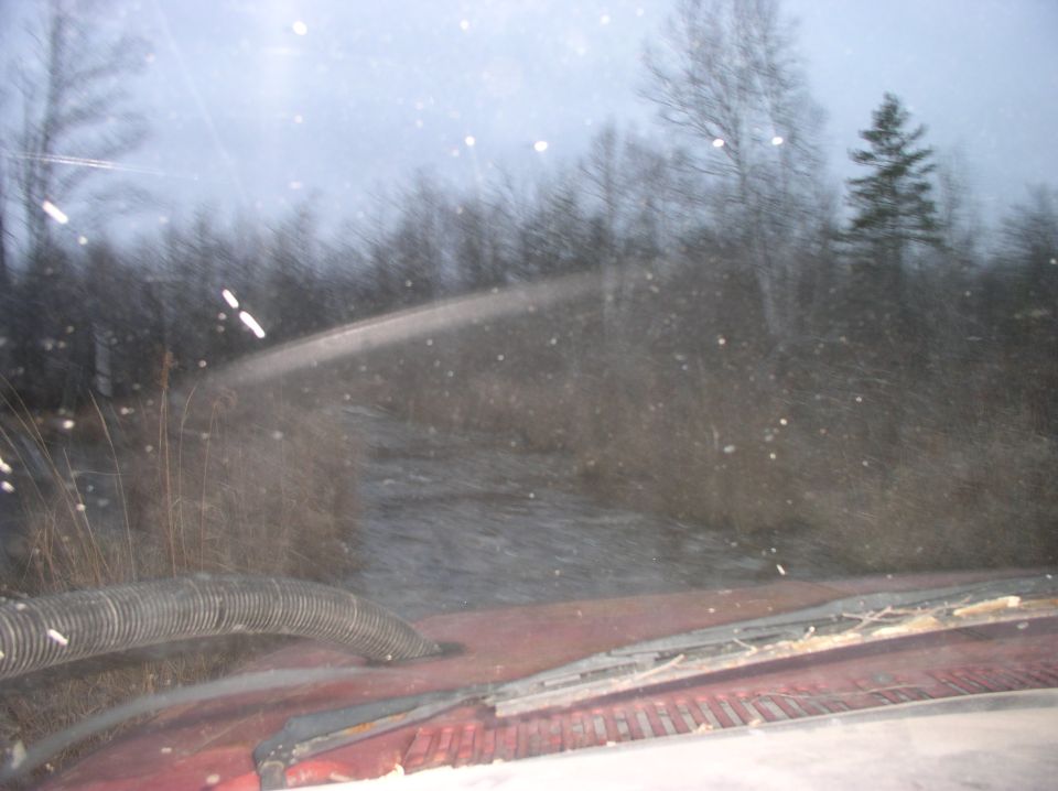 Red truck interior with dashboard and windshield showing a blurry outdoor scene
