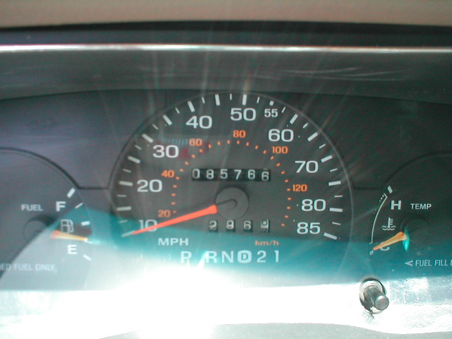 Car dashboard with speedometer, odometer showing 85766, fuel gauge, and temperature gauge