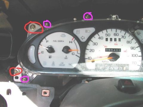 1997 Ford Taurus - Close-up of a vehicle's instrument cluster, highlighting screws for removal.