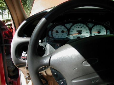 1997 Ford Taurus - The interior of a 1997 Ford Taurus shows the dashboard and steering wheel, with some panels removed for access.