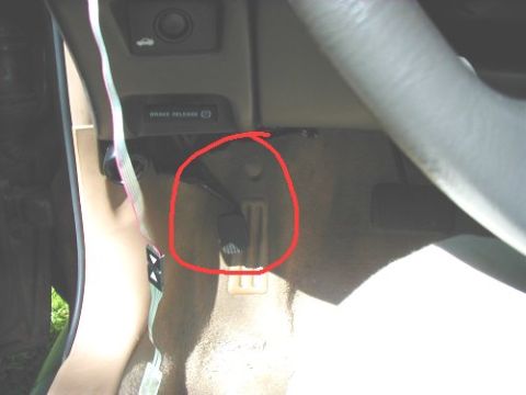 1997 Ford Taurus - Interior view of a car's footwell, highlighting the brake release lever.