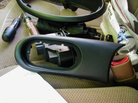 1997 Ford Taurus - Disassembled car interior parts and tools are laid out on a car seat.