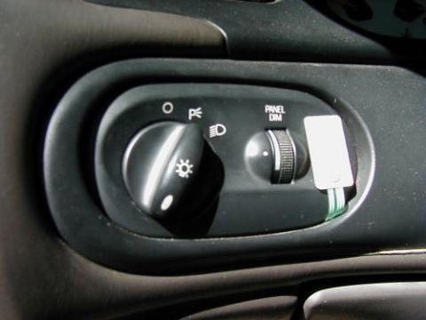 1997 Ford Taurus - Close-up of the headlight and dimmer switch controls within a 1997 Ford Taurus.