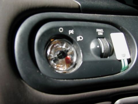 1997 Ford Taurus - Interior view of a vehicle's dashboard controls, including the headlight switch and dimmer.