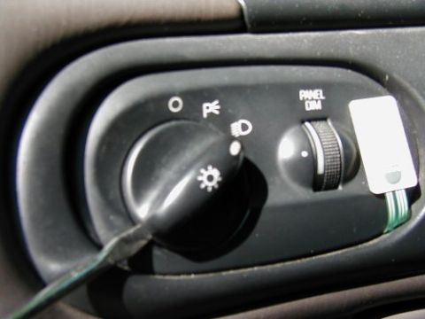 1997 Ford Taurus - The headlight switch has settings for off, parking lights, and headlights, with a separate dimmer for the instrument panel.
