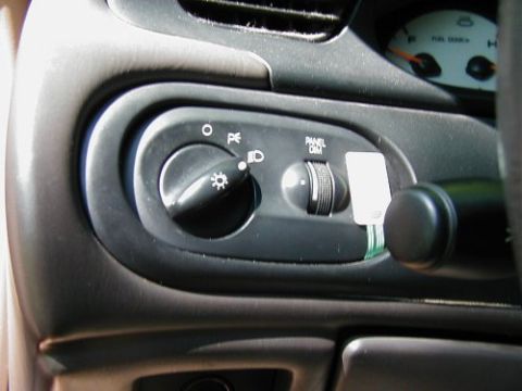 1997 Ford Taurus - Interior view of a 1997 Ford Taurus, showing the headlight controls and part of the instrument cluster.