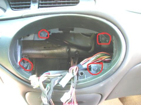 1997 Ford Taurus - Disassembled dashboard interior of a 1997 Ford Taurus, showing exposed wiring and mounting screws.
