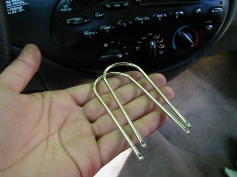 1997 Ford Taurus - Tools are held in front of the car's radio and climate controls.