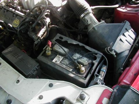 1997 Ford Taurus - The engine bay of a 1997 Ford Taurus, with a focus on the battery and associated components.