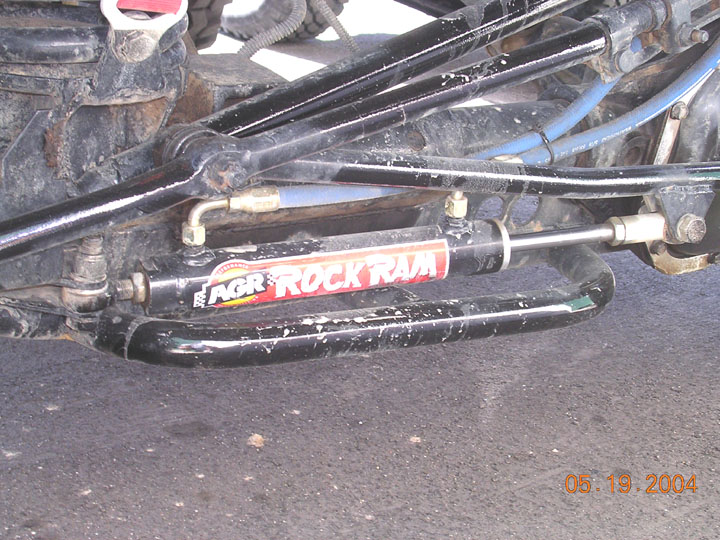 AGR Rock Ram steering stabilizer cylinder mounted on vehicle suspension components