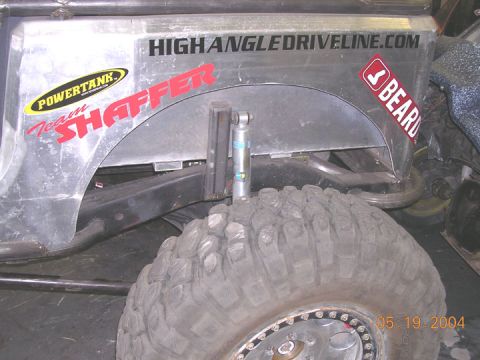 1994 Ford Bronco - Close-up of an off-road vehicle's rear fender, showing custom decals and suspension components.