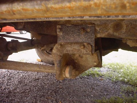 1988 Ford Bronco - Undercarriage view showing rusted frame and suspension components of an older vehicle.