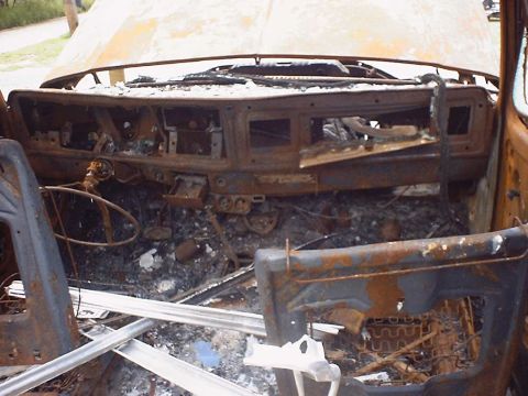 1988 Ford Bronco - The interior of this 1988 Ford Bronco shows significant fire damage, with melted and charred components visible throughout the cabin.
