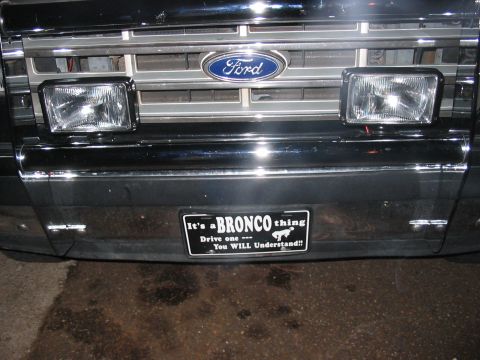 1988 Ford Bronco - Front view of a 1988 Ford Bronco, its grille, bumper, and a novelty license plate.