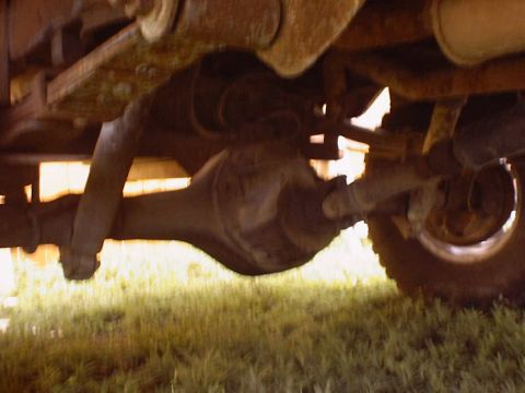1988 Ford Bronco - Close-up of a vehicle's rear axle and suspension system components.