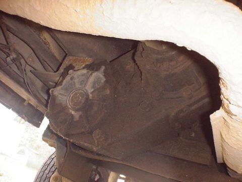 1988 Ford Bronco - Underside view of a vehicle's transfer case, showing mechanical components.