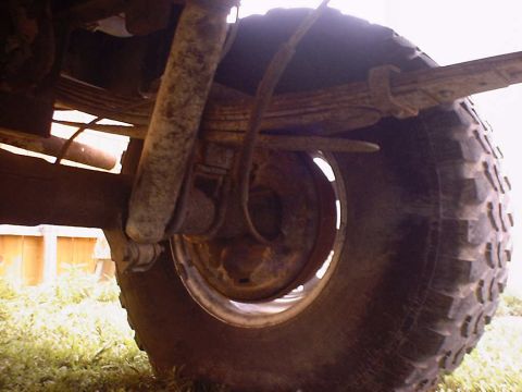 1988 Ford Bronco - The rear suspension and tire of a vehicle are visible in this close-up shot.