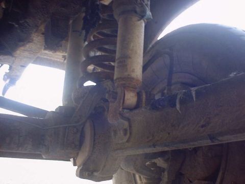 1988 Ford Bronco - Close-up of a vehicle's suspension components, showing rust and wear.