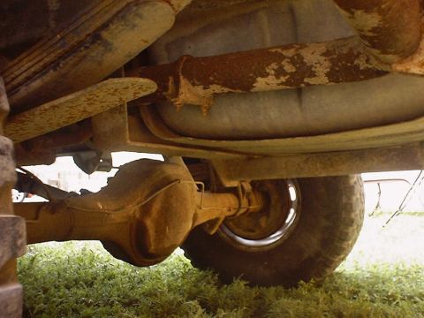 1988 Ford Bronco - The underside of a vehicle reveals its mechanical components, including the rear differential and suspension system.
