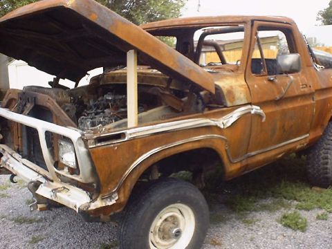 1988 Ford Bronco - This heavily rusted 1978 Ford pickup truck has its hood propped open, revealing the engine.