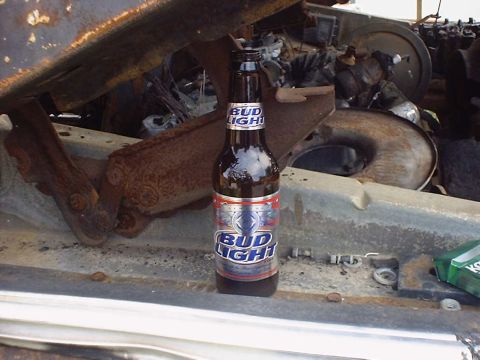 1988 Ford Bronco - A Bud Light bottle sits in a rusty engine bay, with the Supermotors.net logo visible at the bottom.