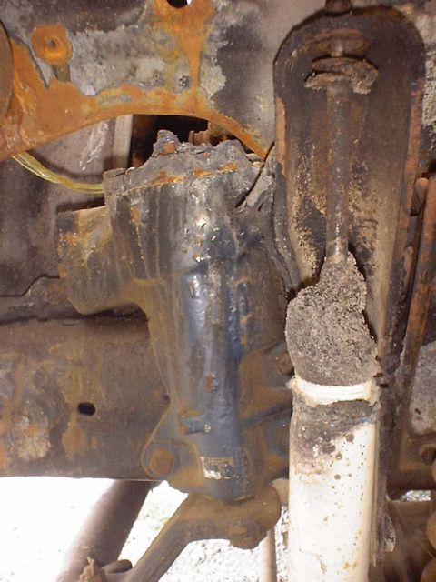 1988 Ford Bronco - The heavily corroded suspension components of a 1988 Ford Bronco are visible in this close-up shot.