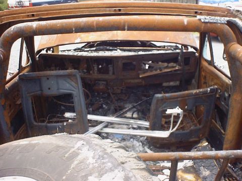 1988 Ford Bronco - The interior of a heavily damaged vehicle, likely a 1978 Ford Bronco, shows extensive fire damage.