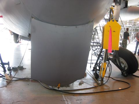 1988 Ford Bronco - Underside view of an aircraft's landing gear and fuselage, showing maintenance equipment.
