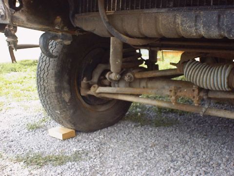 1988 Ford Bronco - Close-up view of the front suspension and tire of a 1988 Ford Bronco.