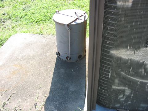 1988 Ford Bronco - A charcoal chimney starter and an air conditioning unit are visible on a concrete pad next to a grassy area.