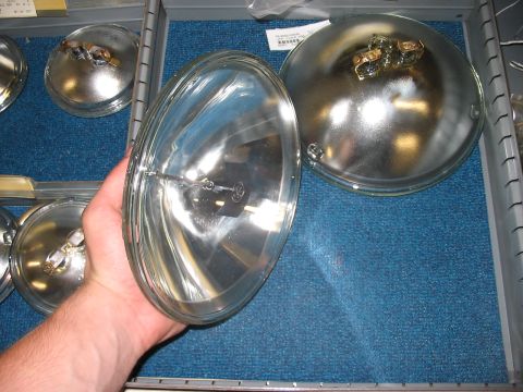 1988 Ford Bronco - Several round headlight assemblies are visible, with one being held in a person's hand.