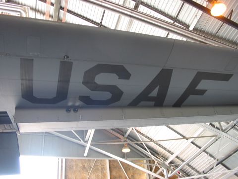 1988 Ford Bronco - Large "USAF" lettering is visible on the fuselage of an aircraft stored indoors.
