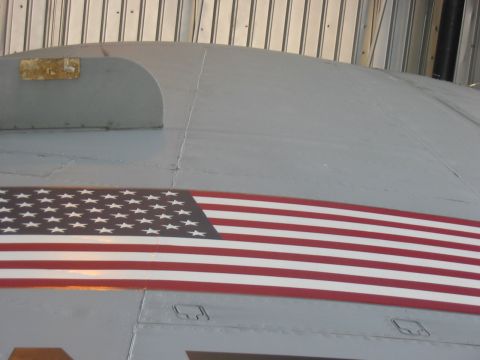 1988 Ford Bronco - This photo shows a portion of an aircraft's exterior, an American flag decal and a watermark from Supermotors.net.