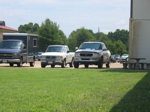 1988 Ford Bronco - A silver pickup truck is parked in a lot with other vehicles visible.