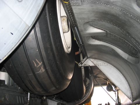 1988 Ford Bronco - Underside view of aircraft landing gear, showing large tires and metallic components.