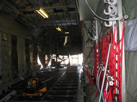 1988 Ford Bronco - The interior of a cargo plane is shown, with lighting and equipment visible.