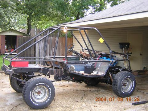 1984 Chevrolet Blazer - Custom buggy frame with roll cage, engine, and tires, seen outdoors.