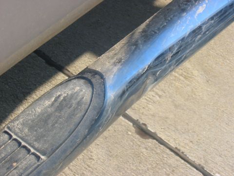 1988 Ford Bronco - Close-up of chrome trim on a vehicle's running board.