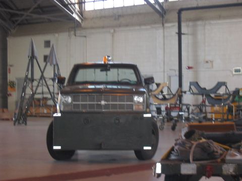 1988 Ford Bronco - This truck features a heavy-duty plow, likely for snow removal, with a grille indicative of an 80s Chevrolet model.