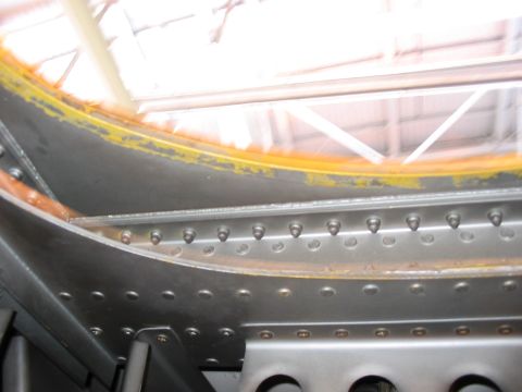 1988 Ford Bronco - Interior view of a riveted metal panel with visible yellow sealant.