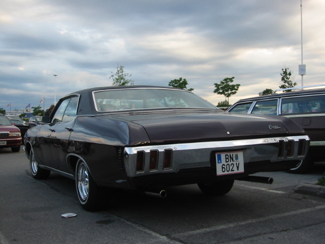 Dark colored 1970 Chevrolet Impala parked, rear view. License plate BN 602 V