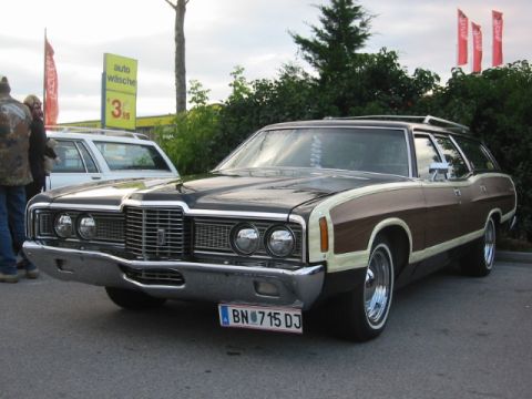 1992 Ford Crown Victoria - This station wagon, with its distinctive wood paneling, is parked in front of a car wash.