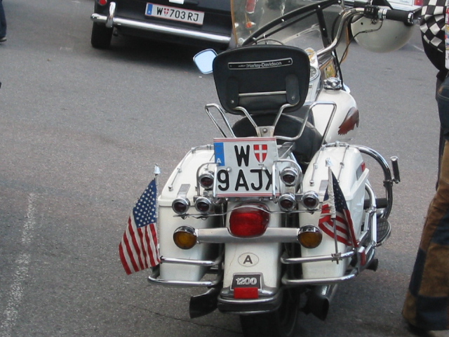 White motorcycle rear with American flags and license plate W 9 AJX