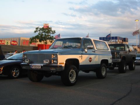 1992 Ford Crown Victoria - A classic Chevrolet K5 Blazer is parked in a lot with another SUV and a car.