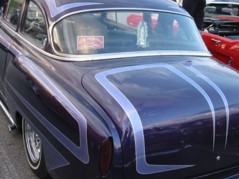1992 Ford Crown Victoria - A customized purple sedan with unique pinstriping is seen from the rear, with another vehicle visible to the right.