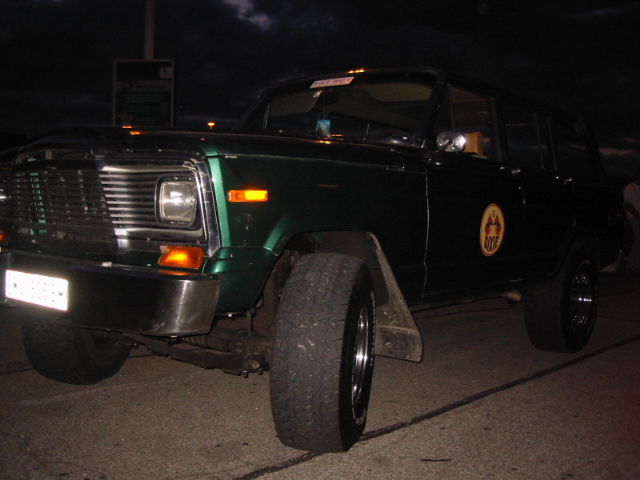 Green SUV with chrome bumper and large tires, viewed from the front quarter